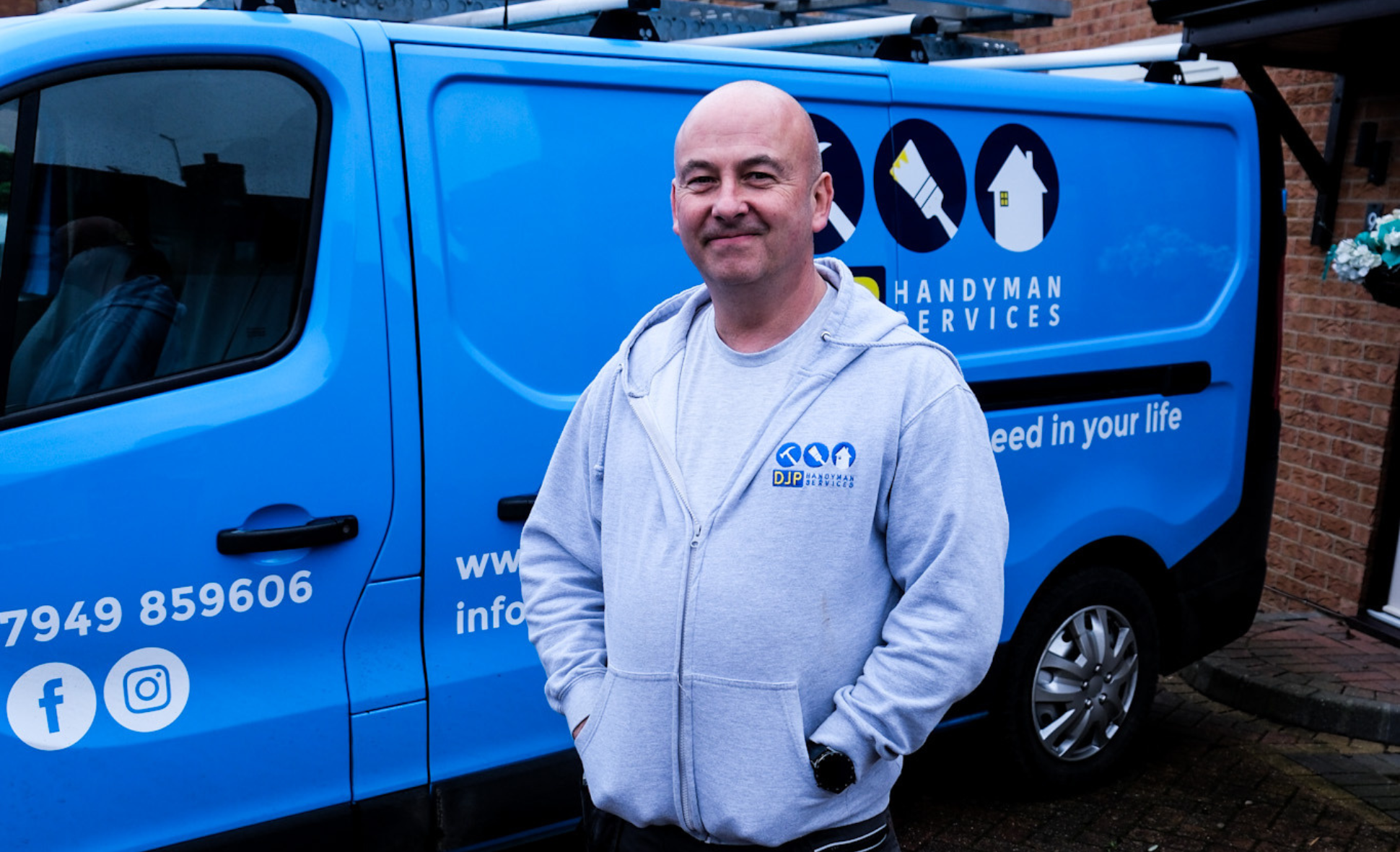 A man standing in front of a blue van