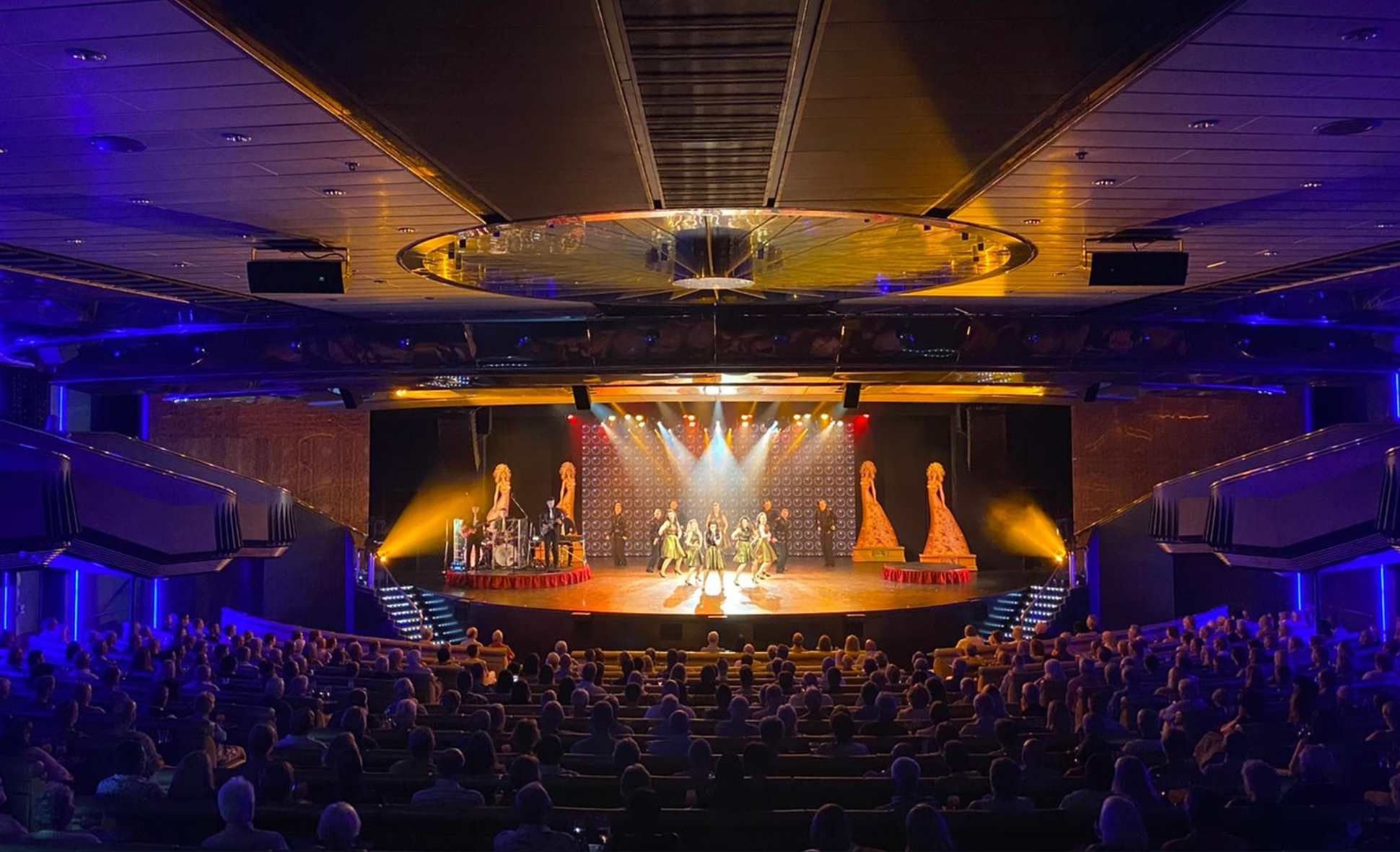 A theatre full of people watching a show on stage